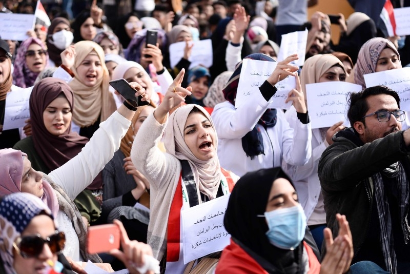 Iraqi university students take part in an anti-government demonstration in Najaf on Sunday. -AFP