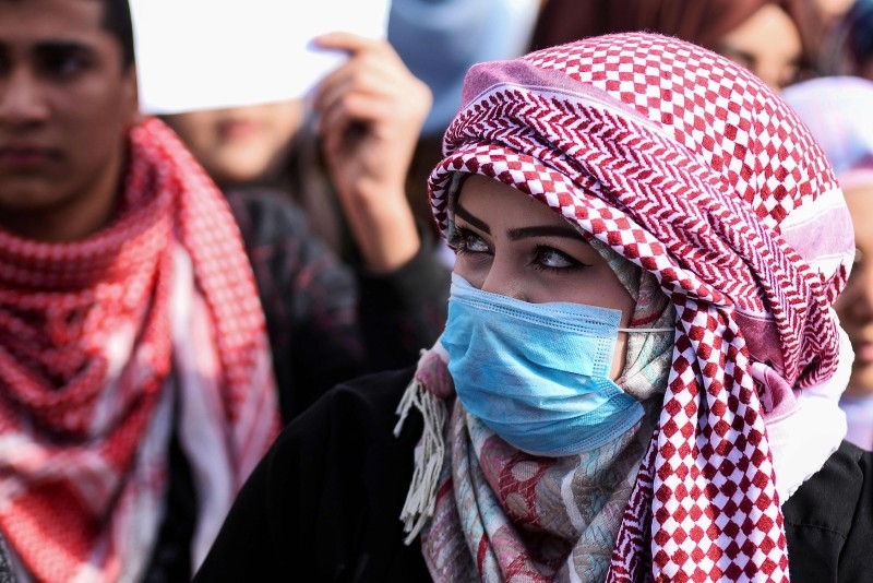 Iraqi university students take part in an anti-government demonstration in Najaf on Sunday. -AFP