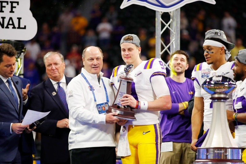 Quarterback Joe Burrow No. 9 of the LSU Tigers receives the S. Truett Cathy Most Outstanding Player trophy after winning the Chick-fil-A Peach Bowl 28-63 over the Oklahoma Sooners at Mercedes-Benz Stadium on Saturday in Atlanta, Georgia. — AFP
