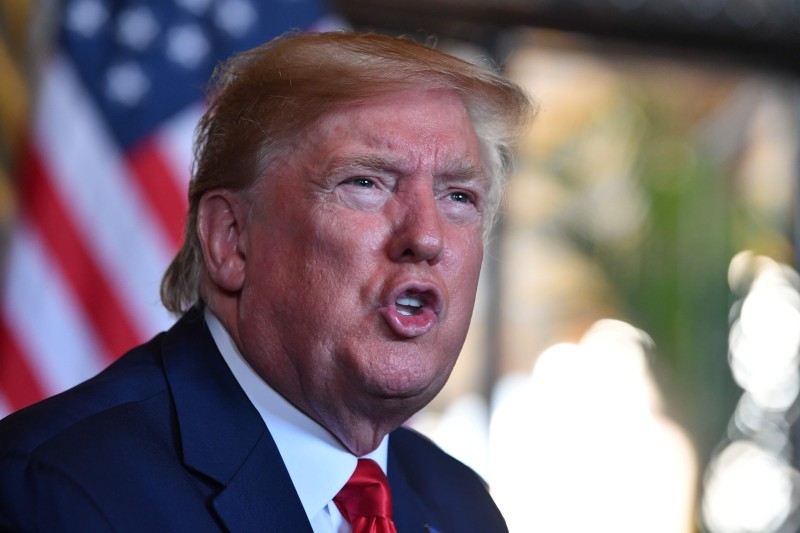  In this file photo taken on December 24, 2019 US President Donald Trump answers questions from reporters after making a video call to the troops stationed worldwide at the Mar-a-Lago estate in Palm Beach Florida. -AFP
