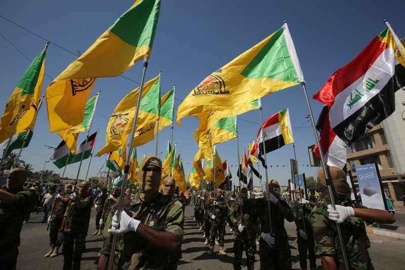 In this file photo taken on May 31, 2019 Iraqi Shiite fighters from the Iran-backed armed group, Hezbollah brigades, march during a military parade marking Al-Quds (Jerusalem) International Day in Baghdad. The US bombed the headquarters of the group in Iraq and Syria, the Pentagon said Sunday, after a series of attacks in Iraq against American interests. -AFP