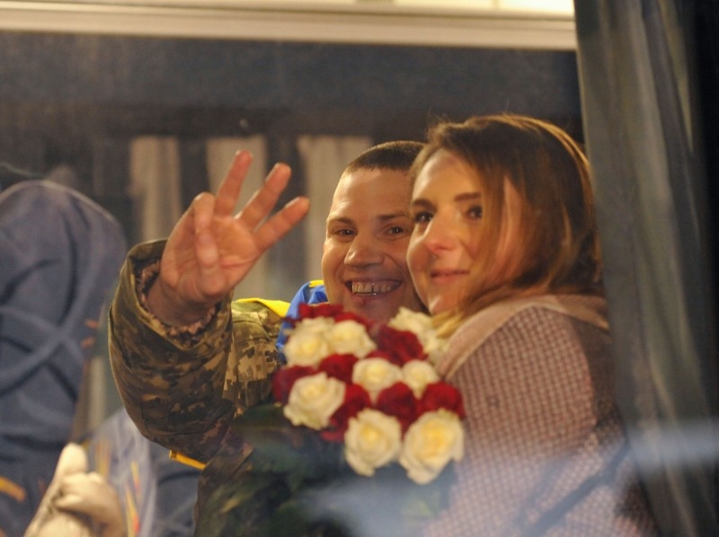 Ukrainians, who were freed by pro-Russian rebels during a prisoner exchange, are welcomed by relatives at the Boryspil airport outside Kiev on Sunday. -AFP