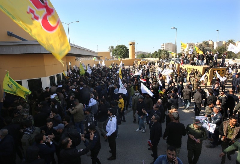 Several thousand Iraqi protesters, waving flags in support of Iraq's Hezbollah movement and the Hashed Al-Shaabi, a mostly Shiite network of local armed groups trained and armed by powerful neighbor Iran, demonstrate outside the US embassy in Baghdad on Tuesday. -AFP
