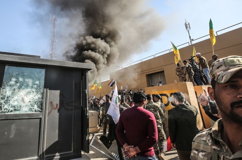 Several thousand Iraqi protesters, waving flags in support of Iraq's Hezbollah movement and the Hashed Al-Shaabi, a mostly Shiite network of local armed groups trained and armed by powerful neighbor Iran, demonstrate outside the US embassy in Baghdad on Tuesday. -AFP