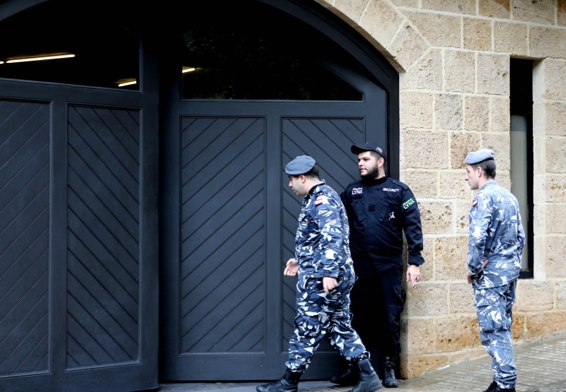 Members of the Lebanon's security forces stand at the parking gate of the house identified by court documents as belonging to former Nissan chief Carlos Ghosn in a wealthy neighborhood of the Lebanese capital Beirut on Tuesday. — AFP