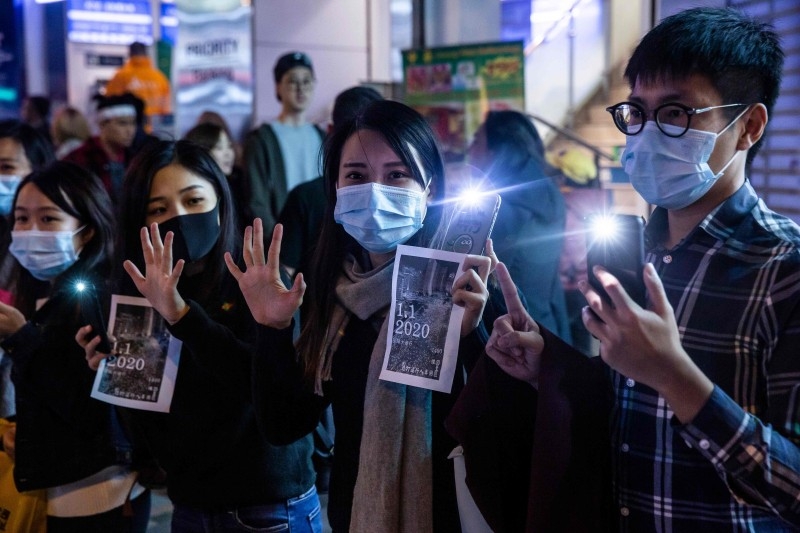 Protesters take part in a human chain rally at the Tsim Sha Tsui district of Hong Kong on Tuesday. — AFP