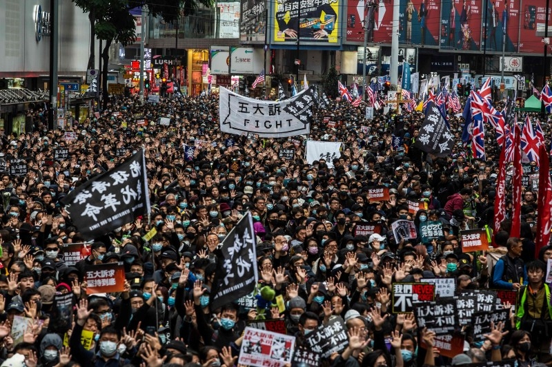 People take part in a pro-democracy march in Hong Kong on January 1, 2020.  Tens of thousands of protesters marched in Hong Kong during a massive pro-democracy rally on New Year's Day, looking to carry the momentum of their movement into 2020.
 / AFP / ISAAC LAWRENCE
