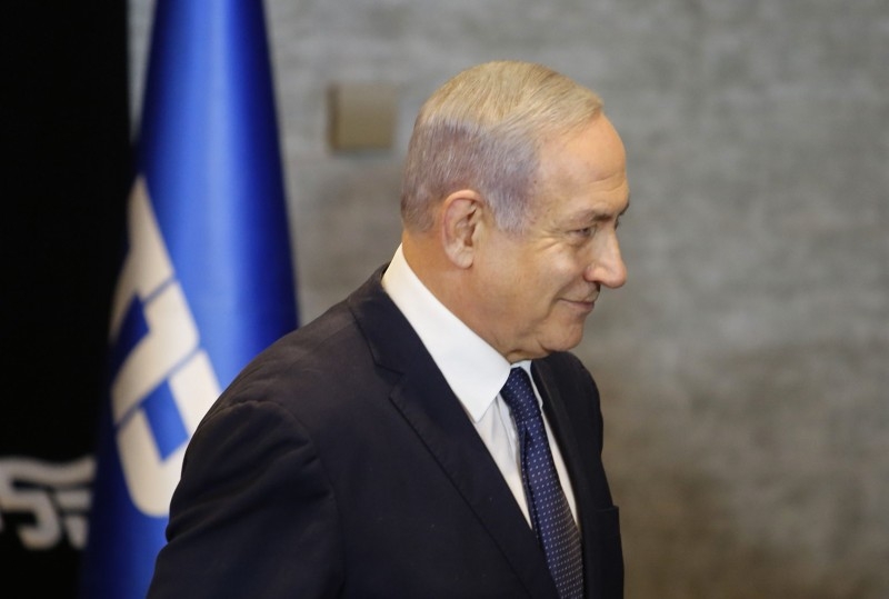 Israeli Prime Minister Benjamin Netanyahu leaves after delivering a statement regarding his intention to file a request to the Knesset for immunity from prosecution, in Jerusalem on Wednesday. — AFP