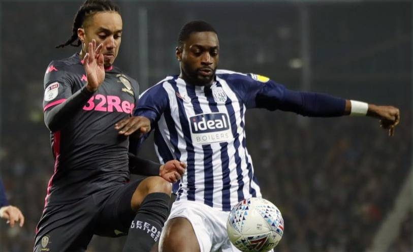 Helder Costa and Semi Ajayi fight for the ball as Leeds and West Brom shared the points in a 1-1 draw at the Hawthorns. — AFP