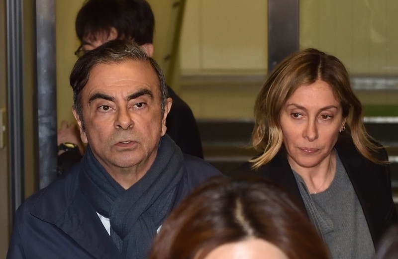 In this file photo taken on April 3, 2019 Former Nissan Chairman Carlos Ghosn (L) and his wife Carole (R) leave the office of his lawyer in Tokyo. — AFP