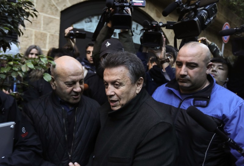 Lebanese lawyer Sakhr Al-Hashem (C) talks to journalists outside a house identified by court documents as belonging to former Nissan chief Carlos Ghosn the capital Beirut, on Thursday. —A FP