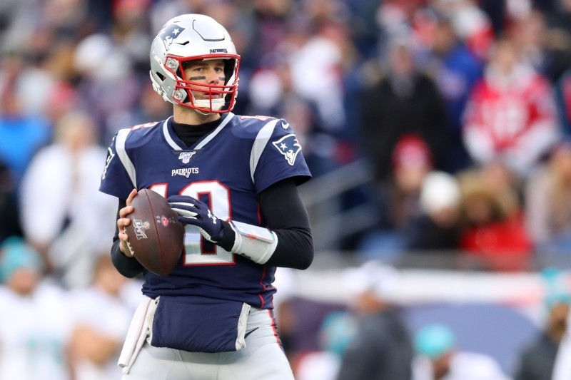 In this file photo taken on Dec. 31, 2019. Tom Brady No. 12 of the New England Patriots looks to pass against the Miami Dolphins at Gillette Stadium in Foxborough, Massachusetts.  Six-time Super Bowl winner Tom Brady leads the defending champion New England Patriots into the NFL playoffs on Saturday against visiting Tennessee in what could be the end of an era. — AFP