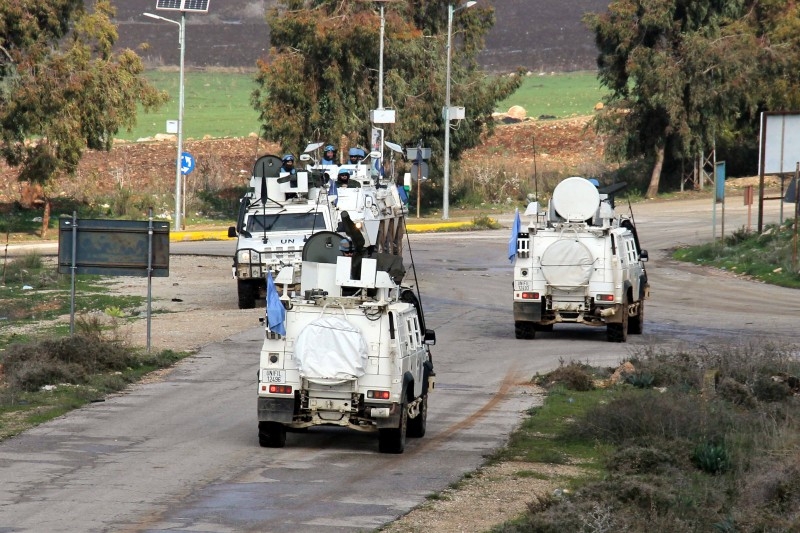 Vehicles of the United Nations Interim Forces in Lebanon (UNIFIL) patrol a road in the southern Lebanese town of Kfar Kila near the border with Israel on Friday. — AFP