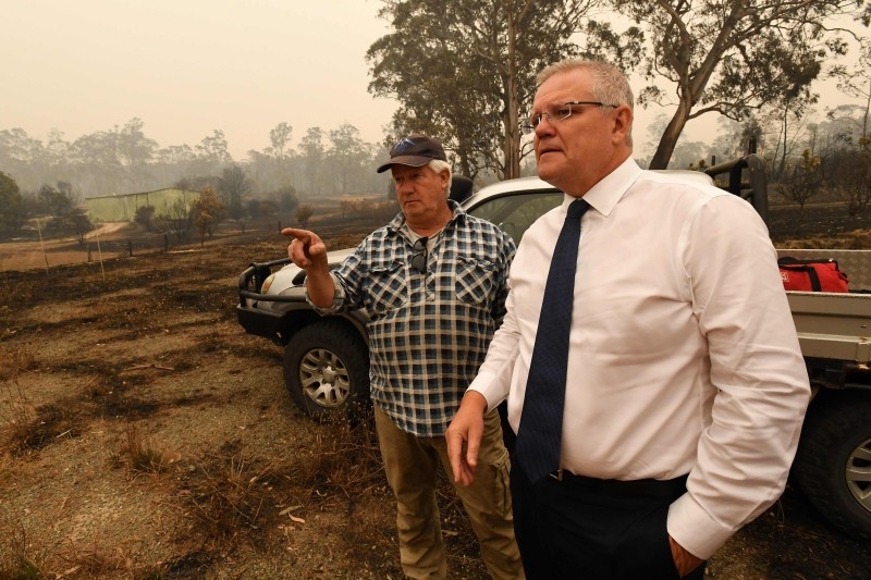 Australia's Prime Minister Scott Morrison (R) visits a wildflower farm in an area devastated by bushfires in Sarsfield, Victoria state on Friday. — AFP