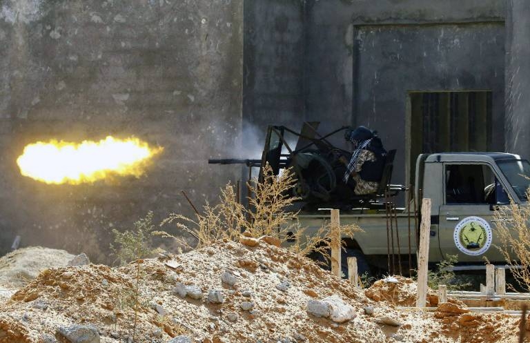 A fighter loyal to Libyan Government of National Accord (GNA) opens fire in clashes with forces loyal to Gen. Khalifa Haftar in suburban Tripoli. — AFP