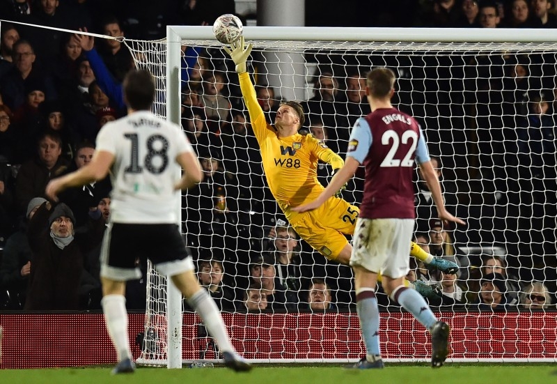 Fulham's Irish midfielder Harry Arter (L) watches as his shot beats the dive of Aston Villa's Norwegian goalkeeper Orjan Nyland for their second goal during the English FA Cup third round football match at Craven Cottage in Fulham, west London on Saturday. — AFP