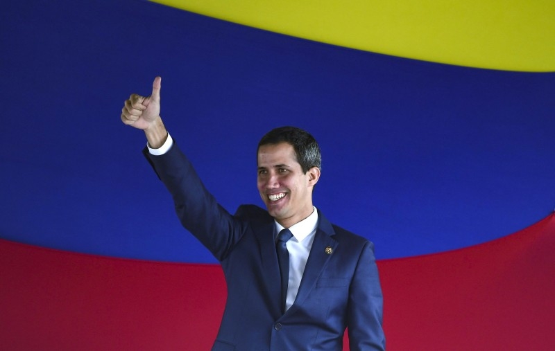 In this file picture taken on July 23, 2019 Venezuelan opposition leader and self-proclaimed interim president Juan Guaido gives the thumb up after voting for rejoining the Inter-American Treaty of Reciprocal Assistance (TIAR) during a session of the opposition-led National Assembly held at Alfredo Sadel square in Caracas. -AFP