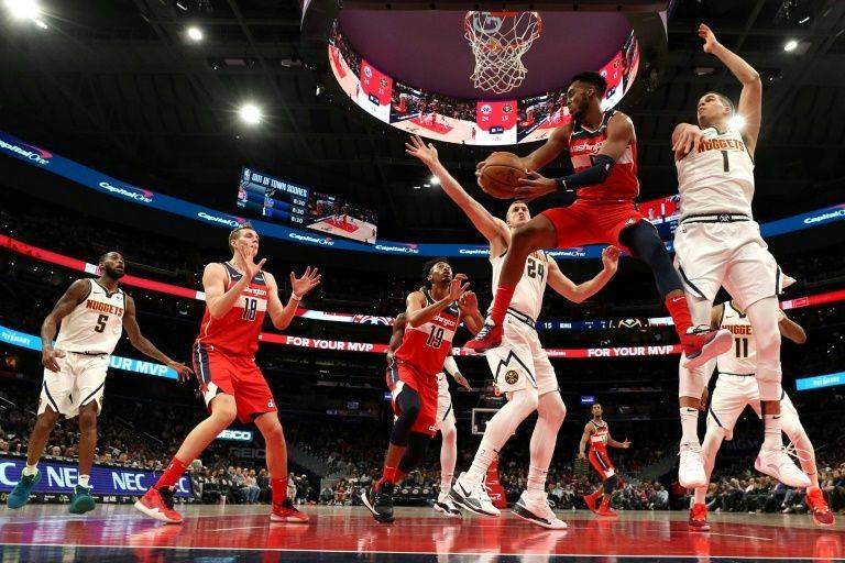 Washington's Troy Brown Jr. looks to pass the ball in front of Denver's Michael Porter Jr. in the Wizards' NBA victory over the Nuggets. — AFP