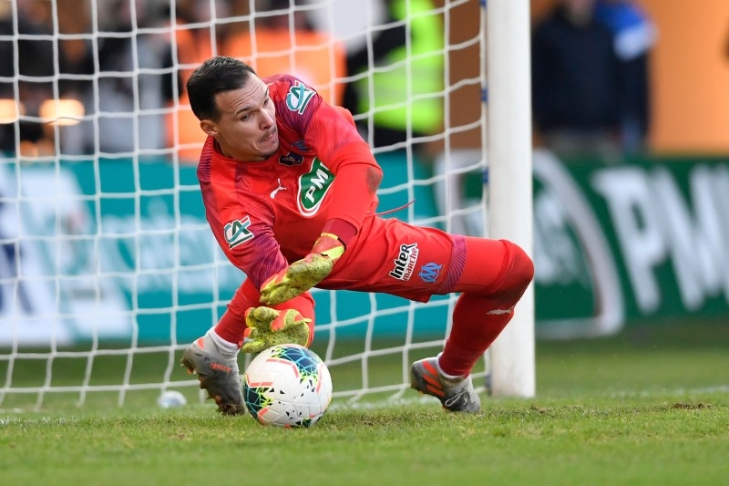 Marseille's French goalkeeper Yohann Pele stops a penalty kick during the penalty shout out during the French cup football match between Trelissac and Marseille on Sunday at the Beaublanc stadium in Limoges, central France. — AFP