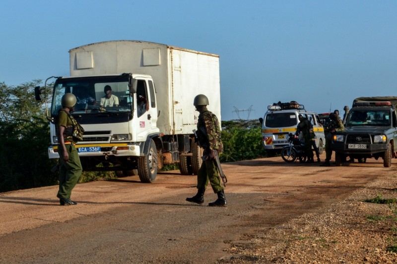 Kenyan police officers check vehicles on a road after a bus, traveling from the coastal region of Lamu to the town of Malindi, was ambushed by gunmen in Lamu county, southeast Kenya, on Jan. 2, 2020. — AFP