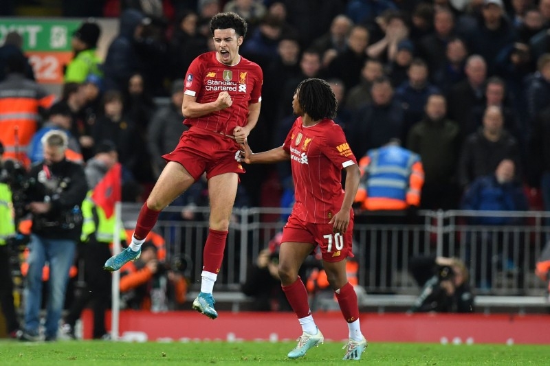Liverpool's English midfielder Curtis Jones (L) celebrates after scoring the opening goal of the English FA Cup third round football match against Everton at Anfield in Liverpool, north west England on Sunday. — AFP