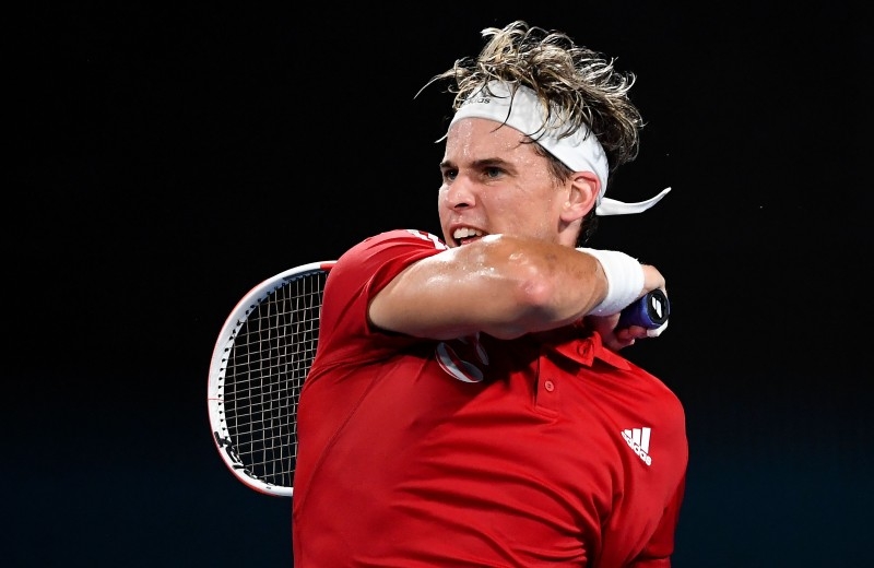 Dominic Thiem of Austria hits a return in his men's singles match against Diego Schwartzman of Argentina at the ATP Cup tennis tournament in Sydney on Monday. — AFP