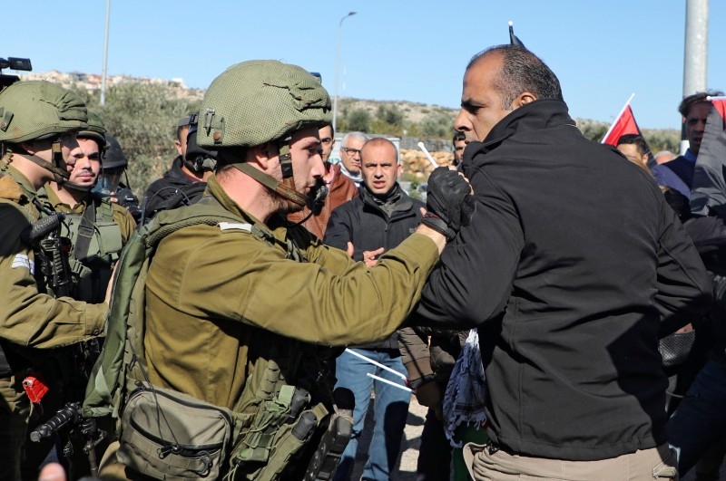 A Palestinian protester confronts an Israeli soldier during a demonstration near the West Bank village of Qalqiliya on Monday. — AFP