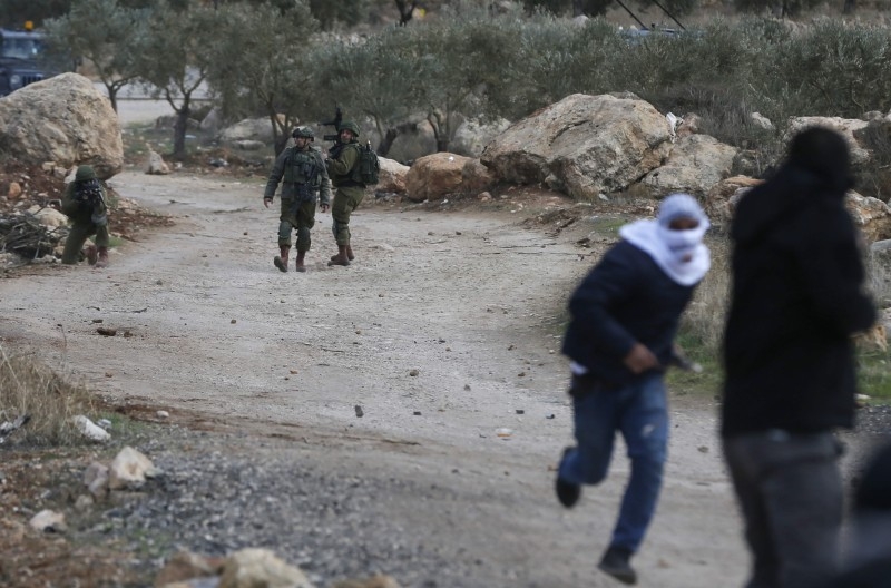 An Israeli soldier aims his weapon at Palestinian demonstrators during a protest against Israeli settlements, in Al-Mughayyir village near Ramallah, in the Israeli-occupied West Bank, in this Jan. 3, 2020 file photo. — AFP