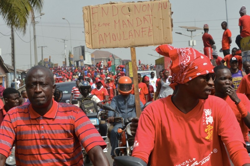 A man holds a placard reading 