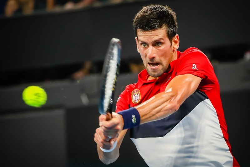 Novak Djokovic of Serbia hits a return against Gael Monfils of France during their men's singles match on day four of the ATP Cup tennis tournament in Brisbane on Monday. — AFP