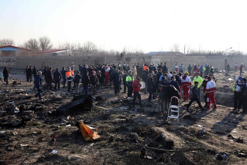 Rescue teams work at the scene after a Ukrainian plane carrying 176 passengers crashed near Imam Khomeini airport in the Iranian capital Tehran early on Wednesday morning, killing everyone on board. -AFP