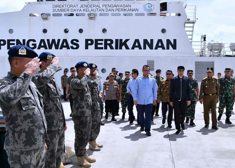 This handout picture taken and released on Wednesday by the Presidential Palace shows Indonesia's President Joko Widodo (4th R) walking with officials during his visit to the Natuna islands, which border the South China Sea. -AFP