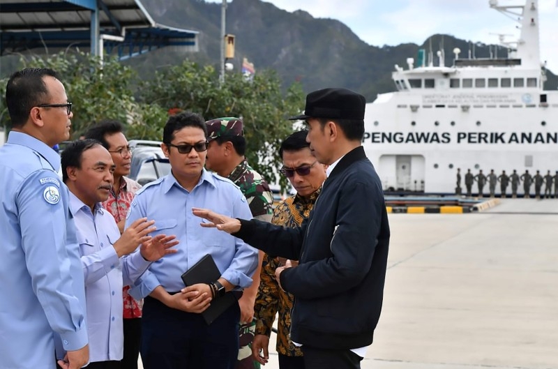 This handout picture taken and released on Wednesday by the Presidential Palace shows Indonesia's President Joko Widodo (4th R) walking with officials during his visit to the Natuna islands, which border the South China Sea. -AFP