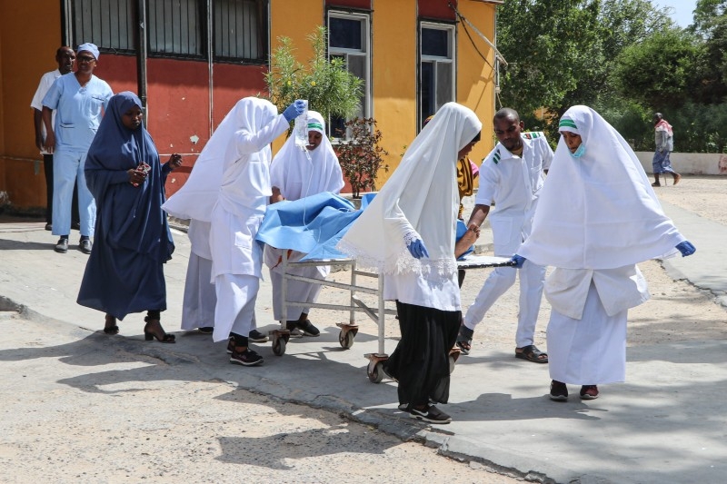 Nurses carry a wounded person on a stretcher after a blast near the Somali parliament at the Medina hospital in Mogadishu, Somalia on Wednesday. -AFP