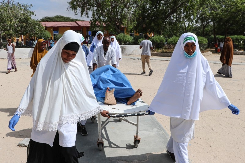 Nurses carry a wounded person on a stretcher after a blast near the Somali parliament at the Medina hospital in Mogadishu, Somalia on Wednesday. -AFP