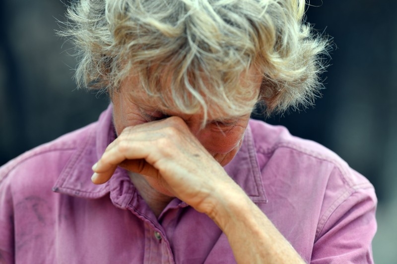 This photo taken on Wenesday shows 64-year-old orchardist Stephenie Bailey reacting as she describes the impact bushfires have had on her farm in Batlow, in Australia's New South Wales state. Batlow has become one of the faces of the destruction wrought by the unprecedented disaster, which also hit areas usually untouched with Australia's summer fires, when shocking images of dead livestock along a road was shared by the national broadcaster ABC. — AFP