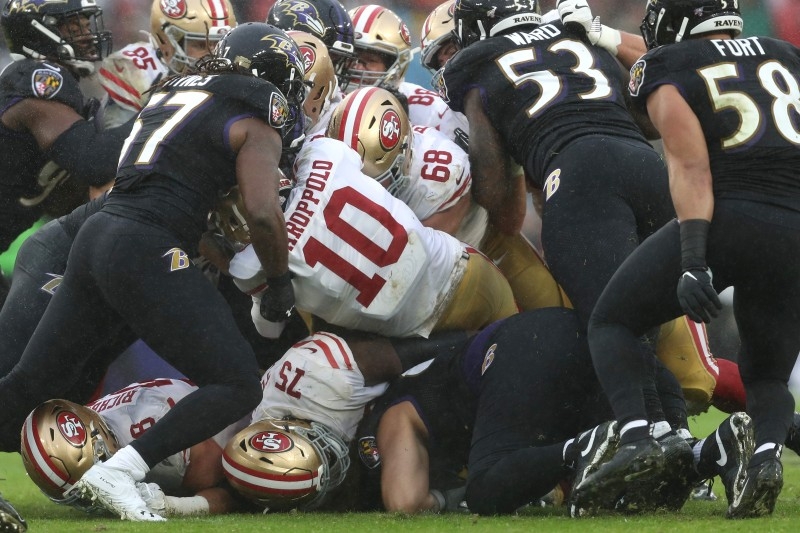 In this file photo taken on Dec. 3, 2019 Quarterback Lamar Jackson No. 8 of the Baltimore Ravens rushes against the San Francisco 49ers at M&T Bank Stadium in Baltimore, Maryland. NFL playoff top seeds Baltimore and San Francisco entertain bottom-seeded upstarts in this weekend's conference semifinal showdowns, providing a supreme test for clubs who have already toppled expected winners. — AFP