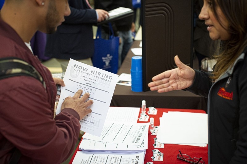 In this file photo taken on Nov. 8, 2019, a Farmland employee offers information to attendees during a Port Authority of New York and New Jersey job fair at the Union County College in Elizabeth, New Jersey. America's solid job creation continued in December but a slower pace while wages cooled off, according to the closely-watched government report released on Friday. — AFP