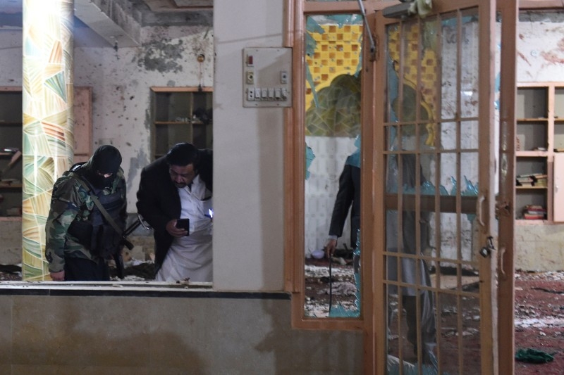 Security officials examine the site after a bomb blast in a mosque in Quetta on Friday. — AFP