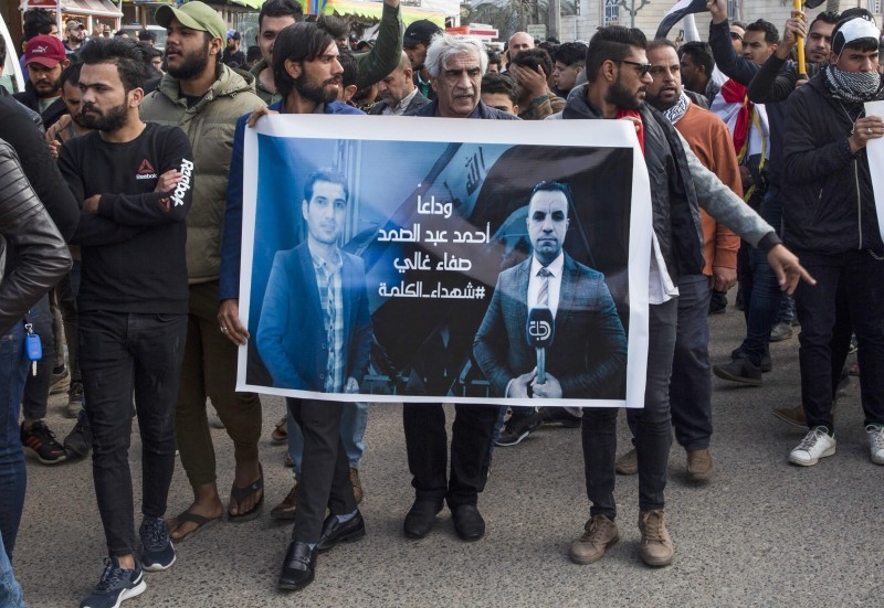 Iraqis take part in a rally on Saturda, to mourn two reporters (image) shot dead the previous evening in the country's southern city of Basra, where they had been covering months of anti-government protests. -AFP
