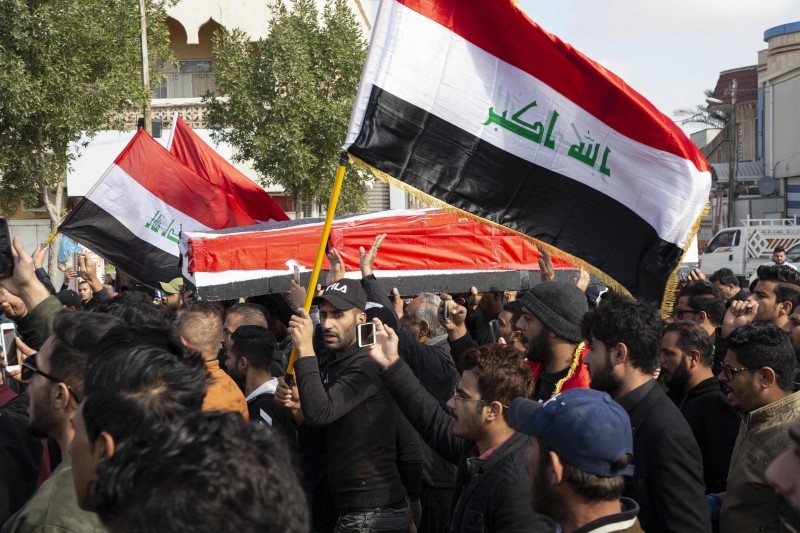 Iraqis take part in a rally on Saturda, to mourn two reporters (image) shot dead the previous evening in the country's southern city of Basra, where they had been covering months of anti-government protests. -AFP