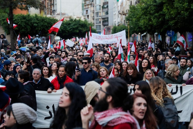 Lebanese demonstrators march during a demonstration near the Electricite du Liban (Electricity Of Lebanon) national company headquarters in the Lebanese capital Beirut on Saturday. — AFP
