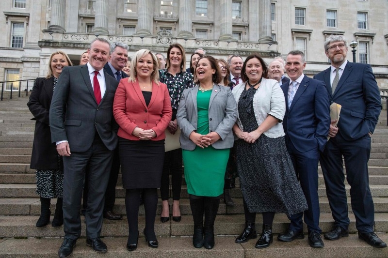 Irish republican Sinn Fein party leader Mary Lou McDonald, center right, with newly appointed Deputy First Minister Sinn Fein's northern leader Michelle O'Neill, center left, pose with MLAs on the steps of the Parliament Buildings on the Stormont Estate in Belfast on Saturday. — AFP