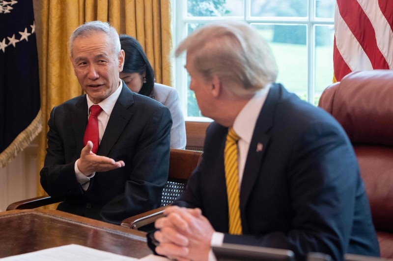 In this file photo China's Vice Premier Liu He (L) speaks with US President Donald Trump during a trade meeting in the Oval Office at the White House in Washington, DC, on April 4, 2019. -AFP