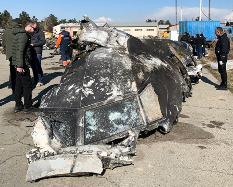 People stand and analyze the fragments and remains of the Ukraine International Airlines plane Boeing 737-800 that crashed outside the Iranian capital Tehran in this Jan. 11, 2019 file photo. — AFP