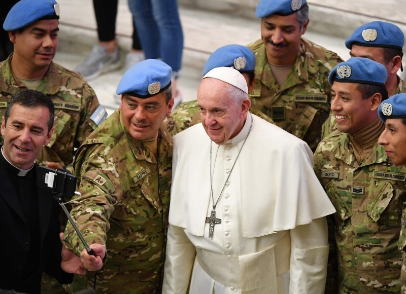 Pope Francis pose for selfie photos as he meets with Argentinian soldiers from the United Nations during the weekly general audience on Jan. 8, 2020 at Paul-VI hall in the Vatican. — AFP