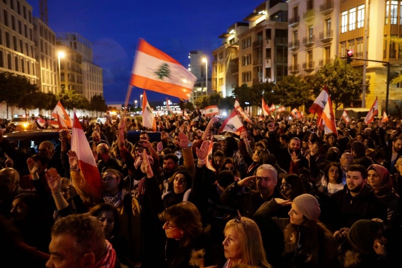 Lebanese demonstrators wave the national flag as they march during a demonstration in downtown Beirut in this Jan. 11, 2020 file photo. — AFP