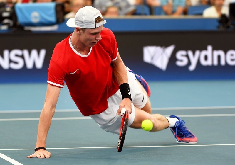 Denis Shapovalov of Canada falls as he hits a volley in his men's singles match against Novak Djokovic of Serbia at the ATP Cup tennis tournament in Sydney on Jan. 10, 2020. — AFP