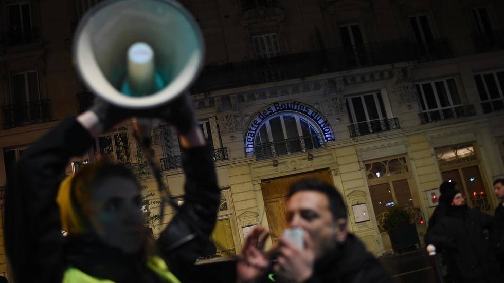 Macron rushed from Paris theater during protest