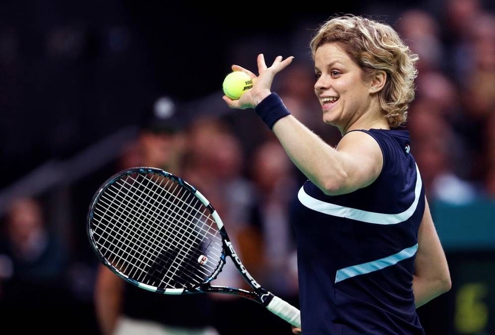 Belgium's Kim Clijsters waves to supporters during an exhibition tennis match against Venus Williams in Antwerp to mark Clijsters' retirement, Dec. 12, 2012. — Reuters